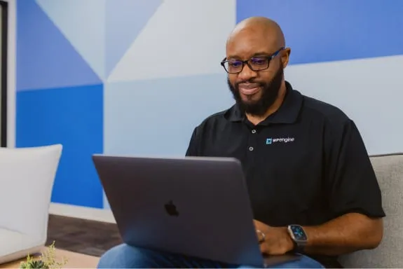 WP Engine employee looking at laptop screen