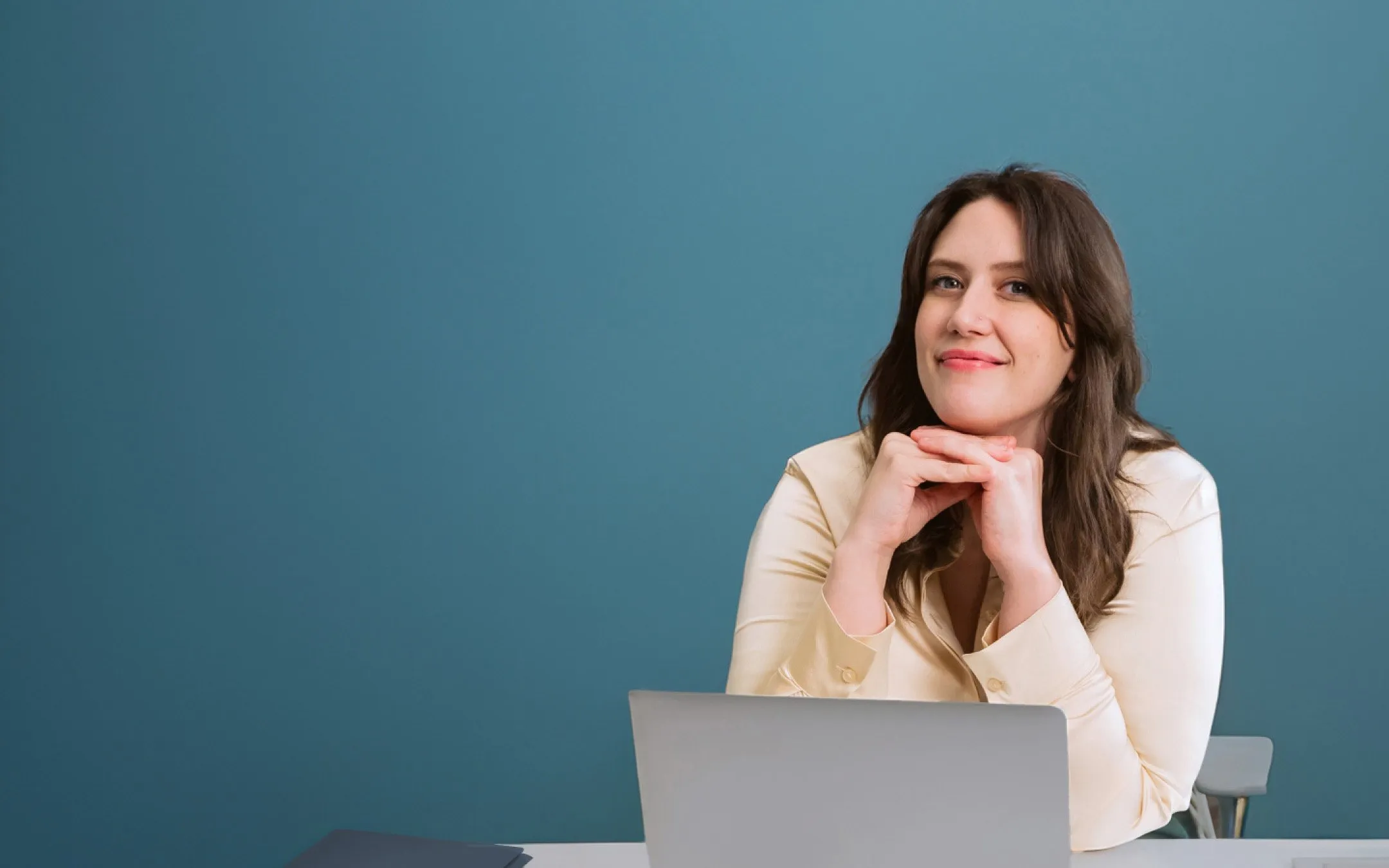 Happy user sitting at laptop and looking up